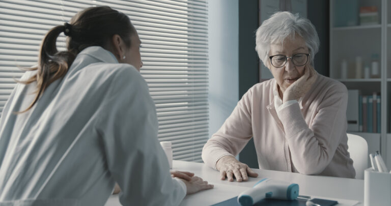 Caring Doctor Assisting A Senior Patient
