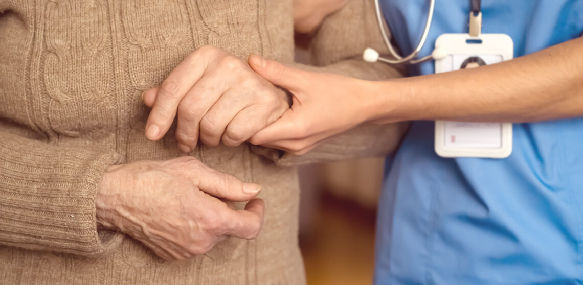 Young Woman's Hands Hold Grandmother's Hands, An Elderly Patient.