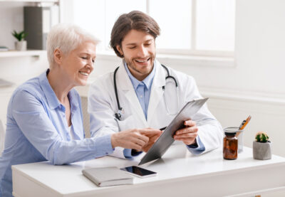 Doctor Showing Recommendations To Senior Woman Patient